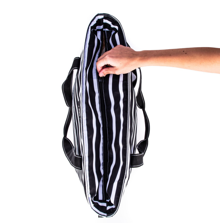 A large, soft cooler you can sling over your shoulder like a tote bag? Sign up here! The molded bottom stands up to any surface and it comes with a long, detachable strap for carrying versatility. Not just reserved for snacks and drinks either.