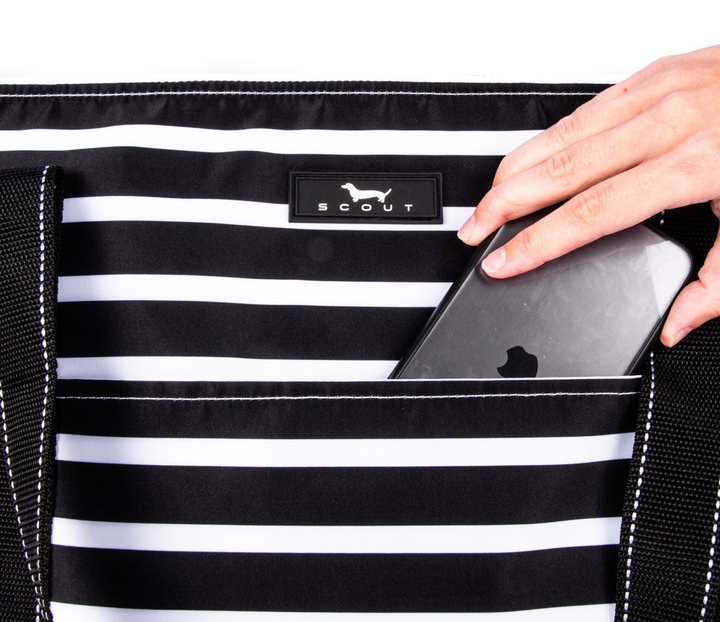 A large, soft cooler you can sling over your shoulder like a tote bag? Sign up here! The molded bottom stands up to any surface and it comes with a long, detachable strap for carrying versatility. Not just reserved for snacks and drinks either.