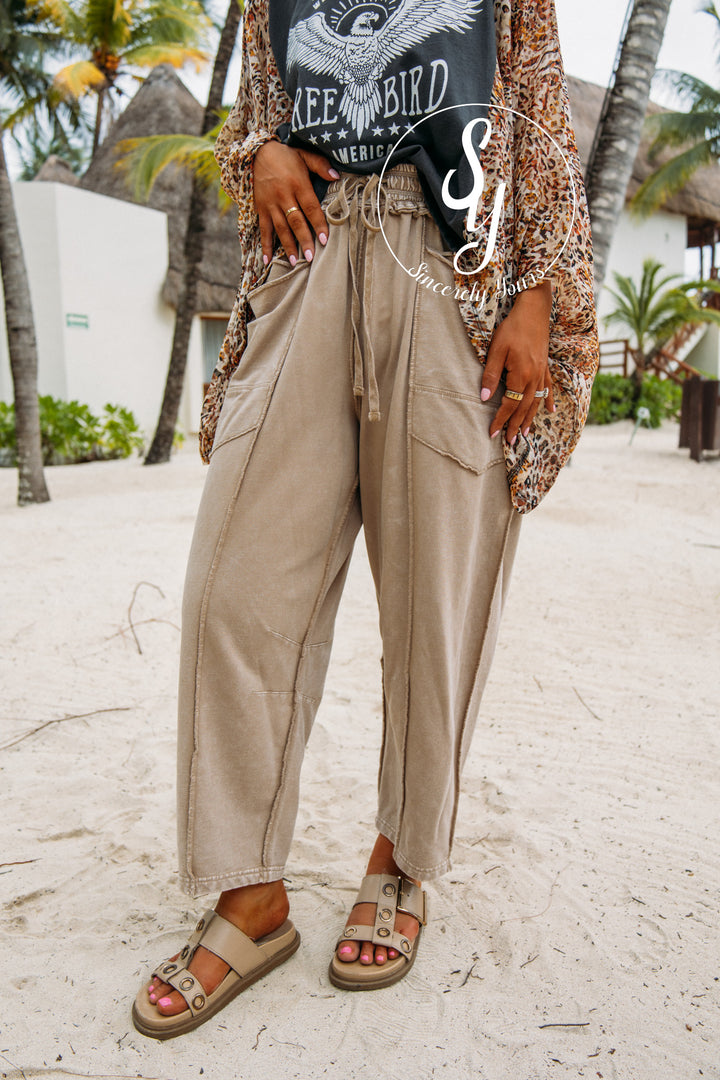 beige pants and sandals paired with graphic tee