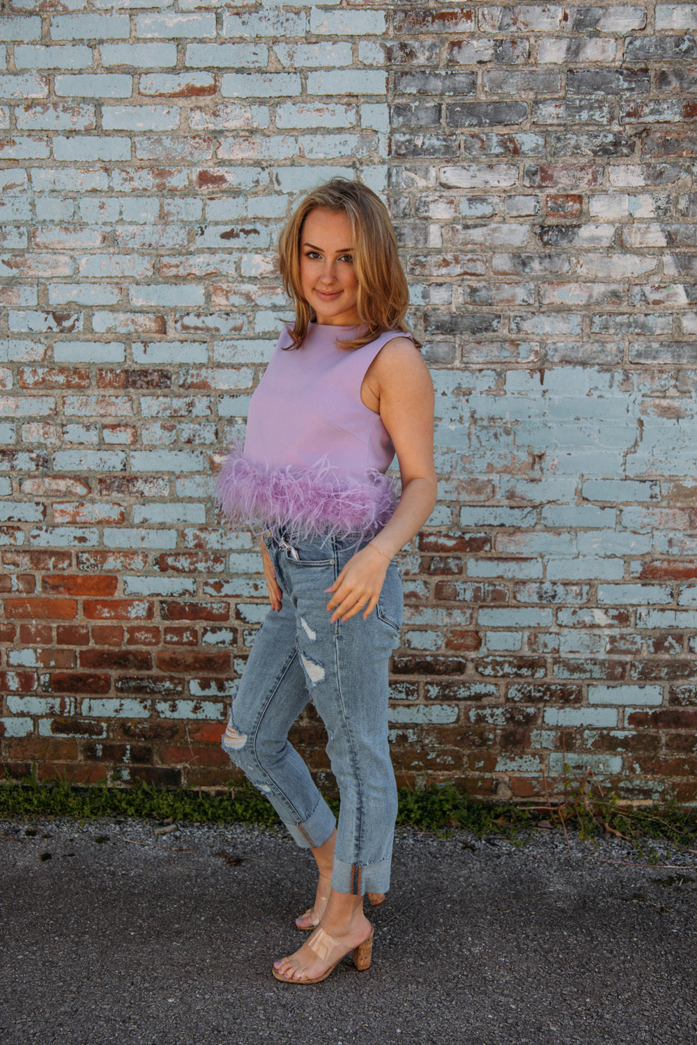 This top has to be one of our new FAVS!! Pair it with jeans and heels for the perfect girly girl on the go look!! No matter what occasion, it will be sure to make a statement this summer!  Natalie is 5'2 wearing a size small feather trim detailing 95% polyester, 5% spandex