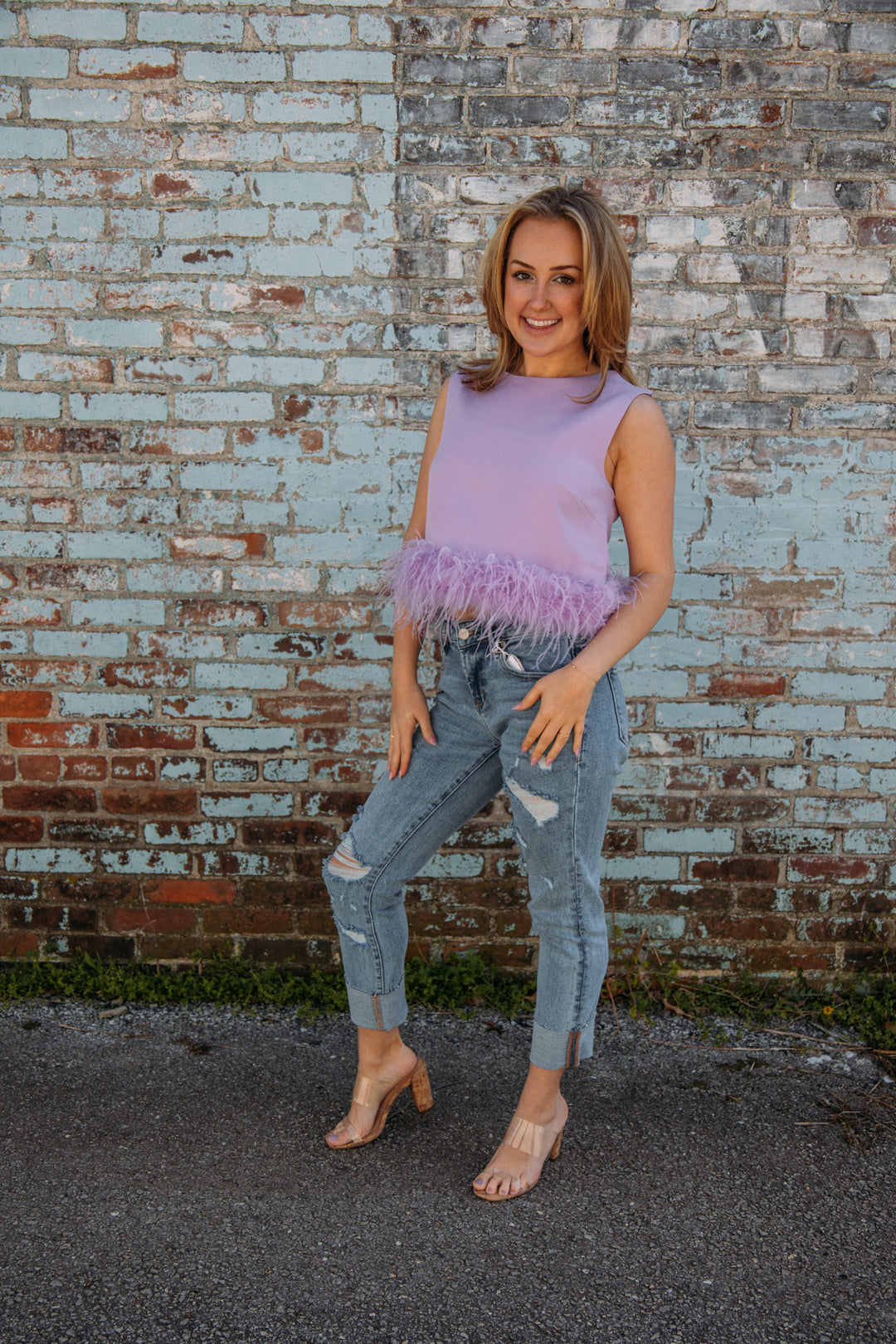 This top has to be one of our new FAVS!! Pair it with jeans and heels for the perfect girly girl on the go look!! No matter what occasion, it will be sure to make a statement this summer!  Natalie is 5'2 wearing a size small feather trim detailing 95% polyester, 5% spandex