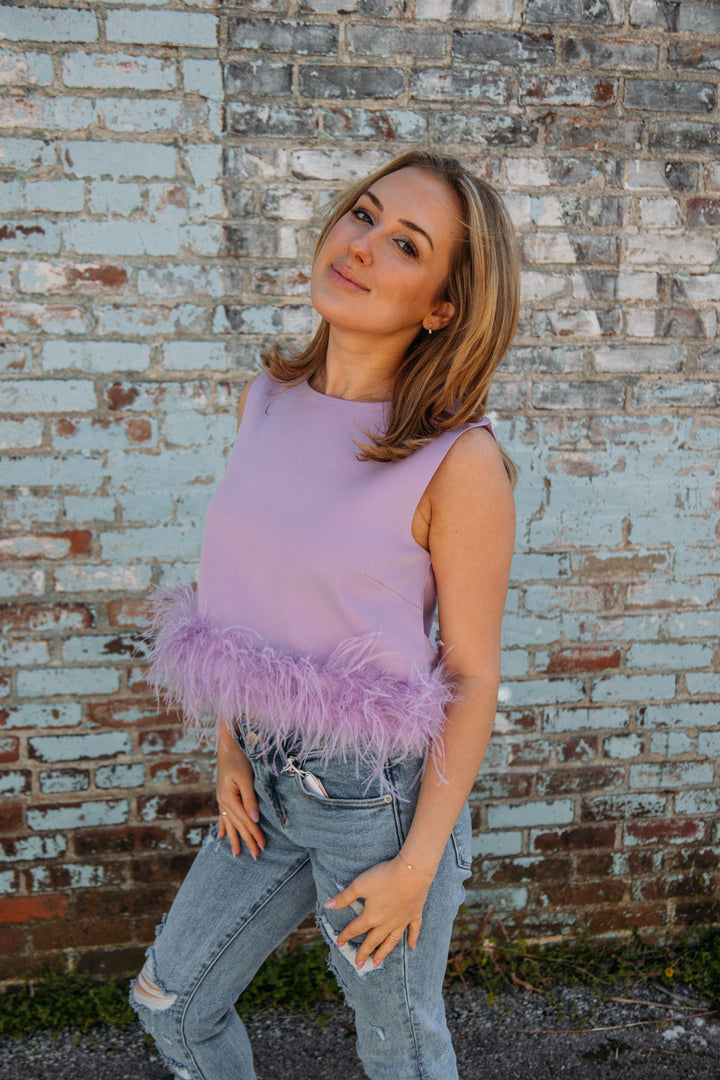 This top has to be one of our new FAVS!! Pair it with jeans and heels for the perfect girly girl on the go look!! No matter what occasion, it will be sure to make a statement this summer!  Natalie is 5'2 wearing a size small feather trim detailing 95% polyester, 5% spandex