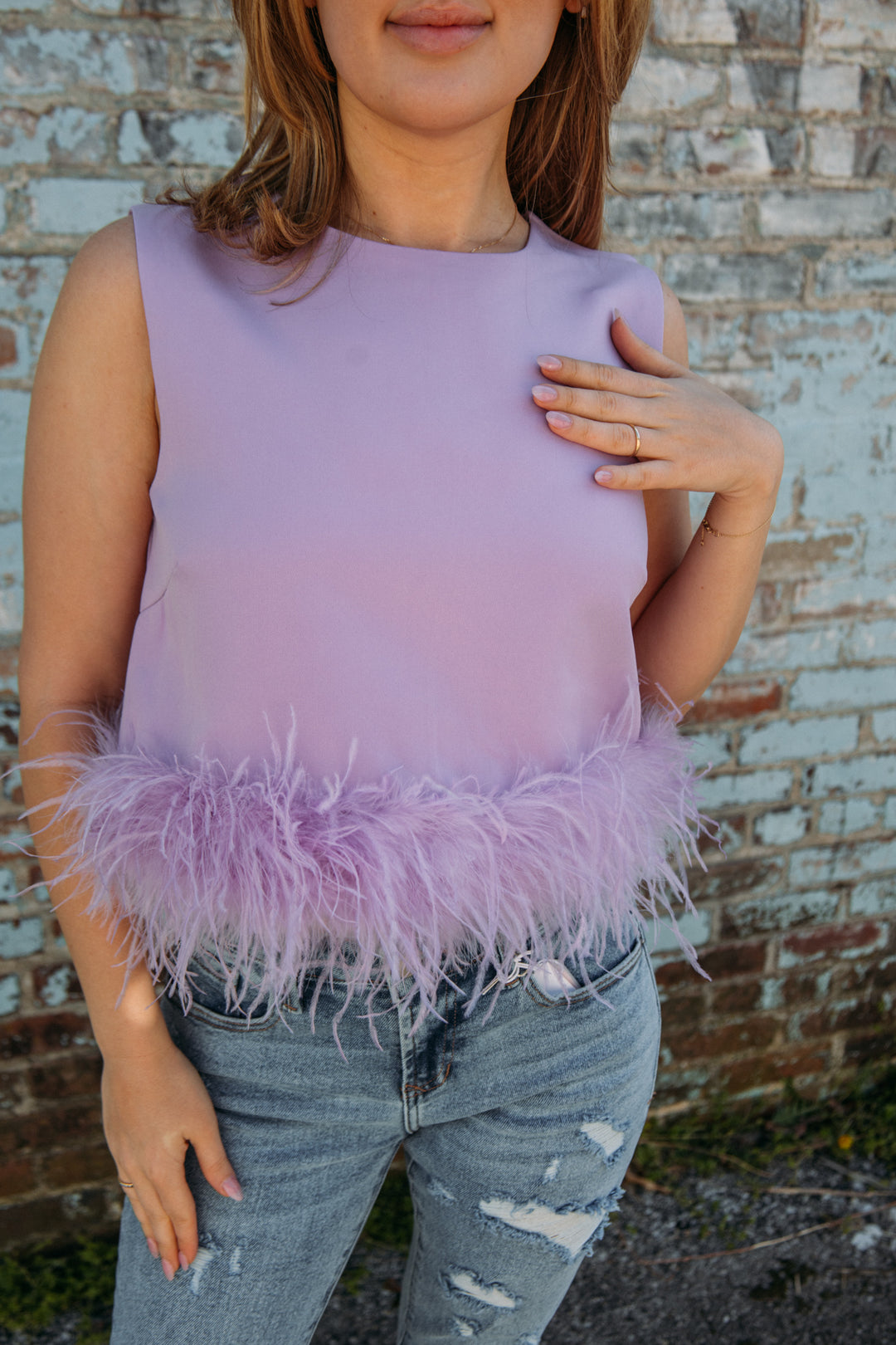 This top has to be one of our new FAVS!! Pair it with jeans and heels for the perfect girly girl on the go look!! No matter what occasion, it will be sure to make a statement this summer!  Natalie is 5'2 wearing a size small feather trim detailing 95% polyester, 5% spandex